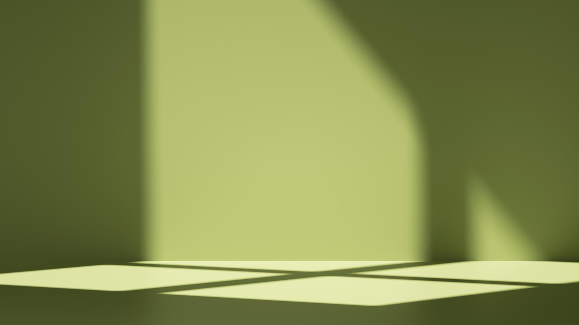 simple abstract green background with shadows and illuminated with bright sunlight going through the window