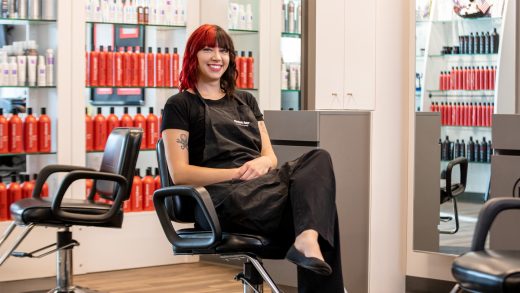Woman smiling and sitting in salon chair