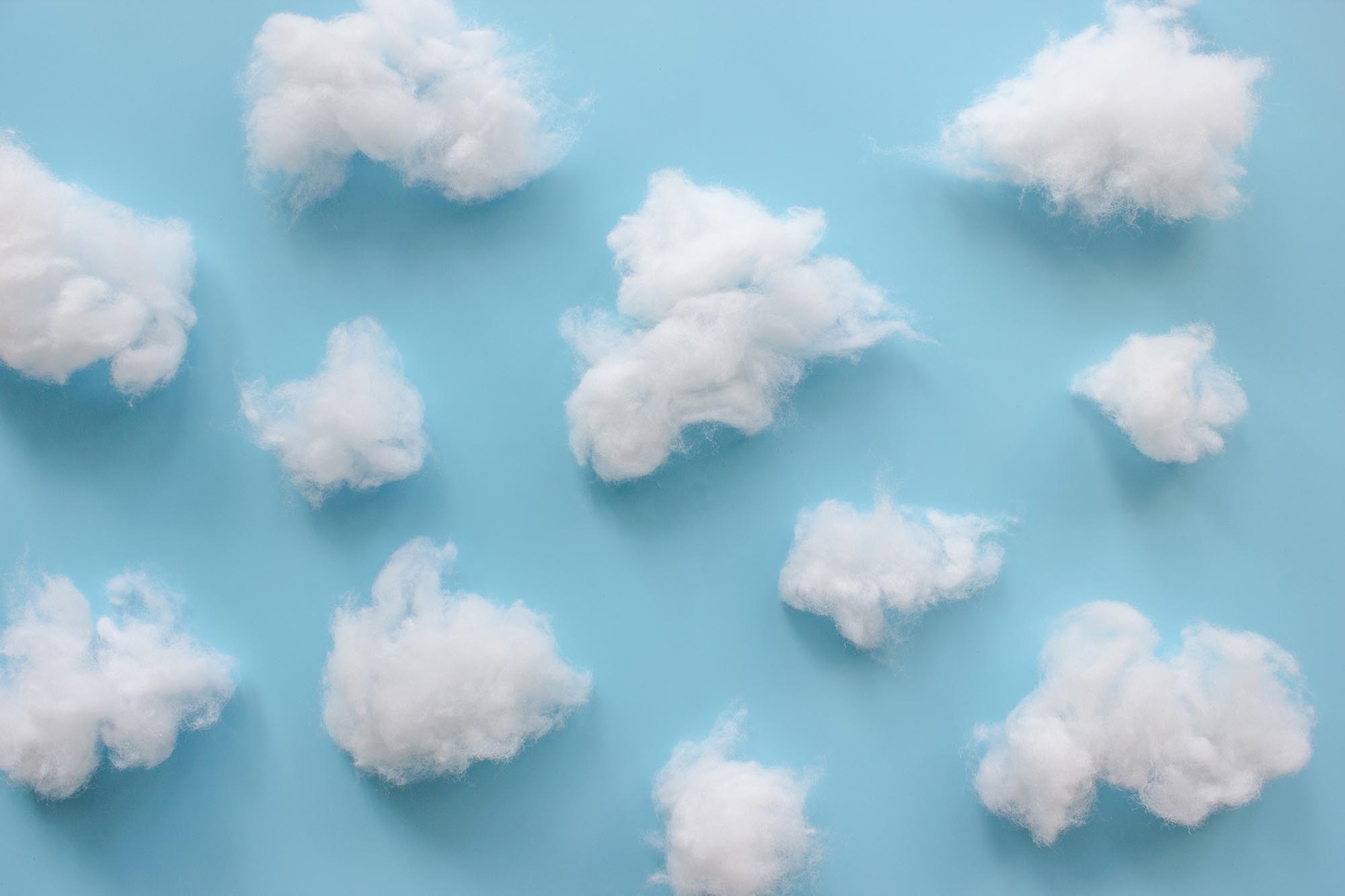 Cotton wool clouds on light blue background