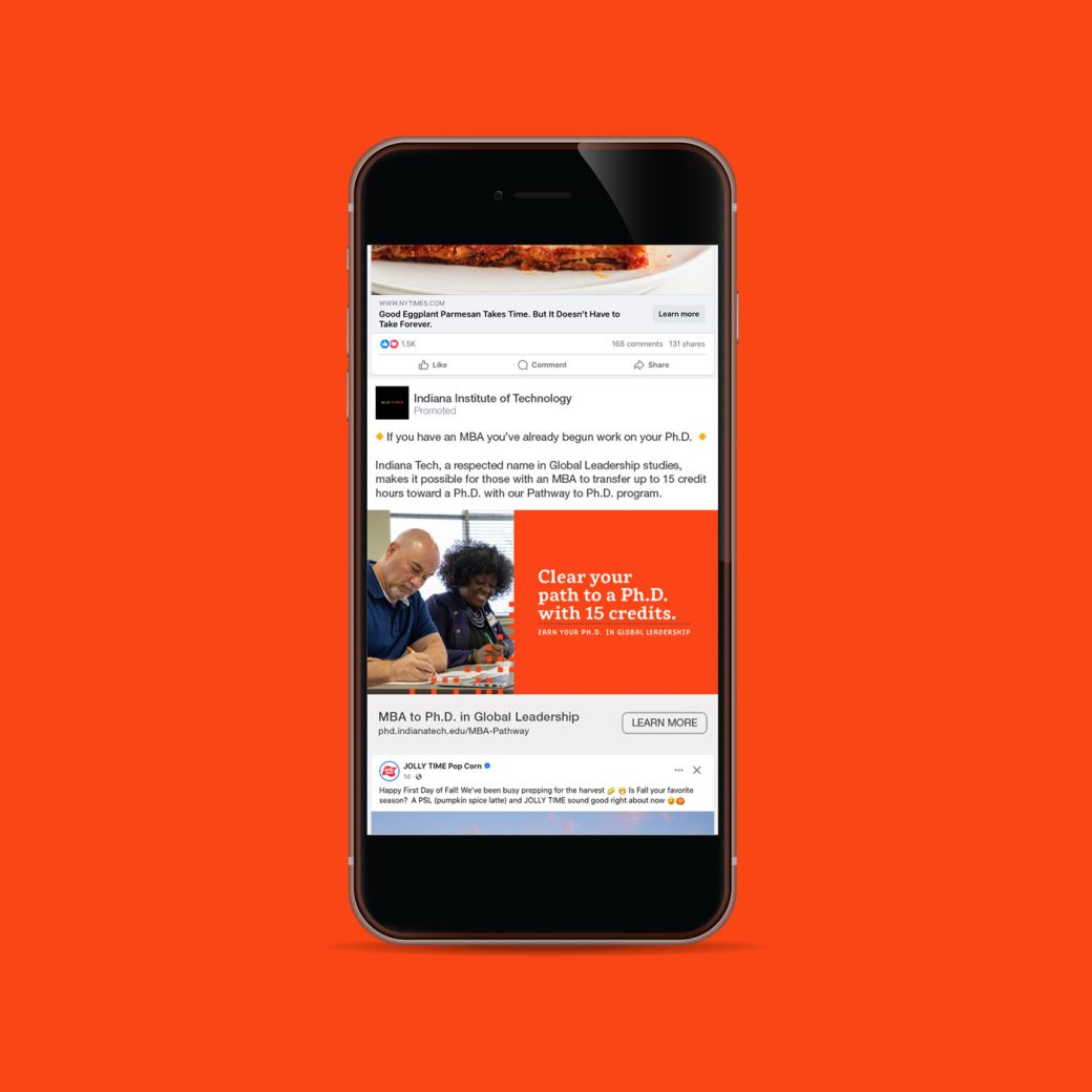 Phone screen showing Indiana Tech social media on orange background