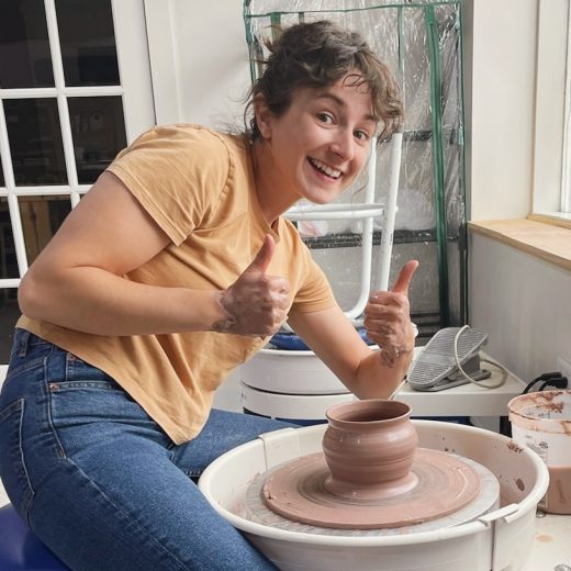 Jeanie sitting at pottery wheel