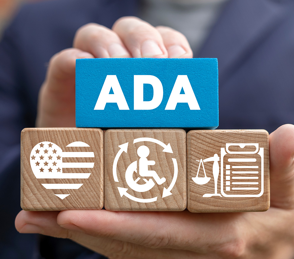 Hands holding blocks that say ADA