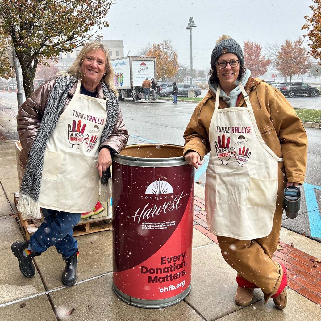 Mary Kinder and Jill Brown collecting turkeys for Community Harvest Food Bank's turkey rally.