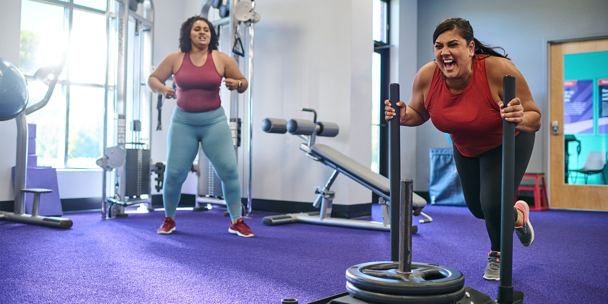 two women exercising at an Anytime Fitness gym