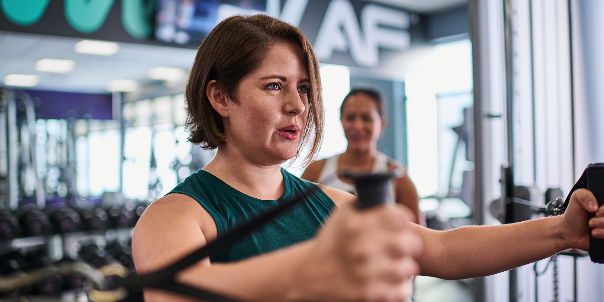 woman at the gym using a cable machine