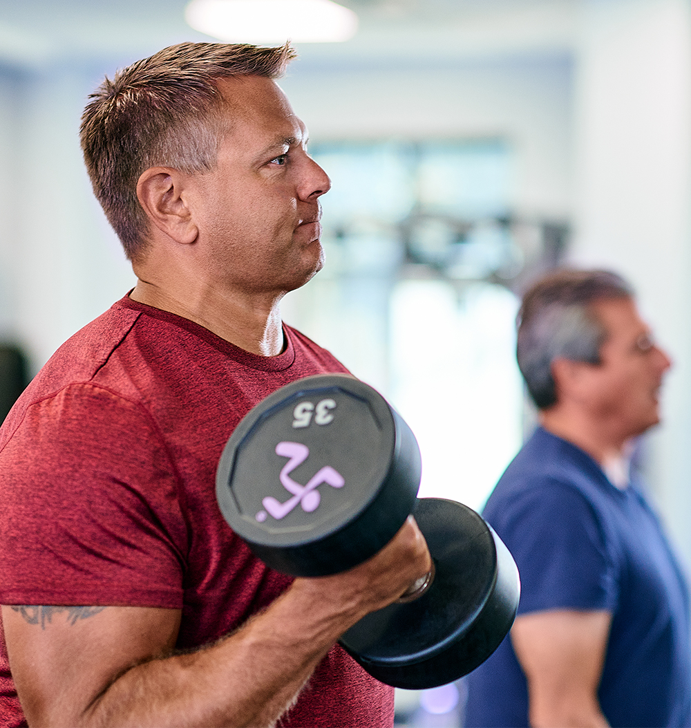 Man lifting 35 pound dumbbell