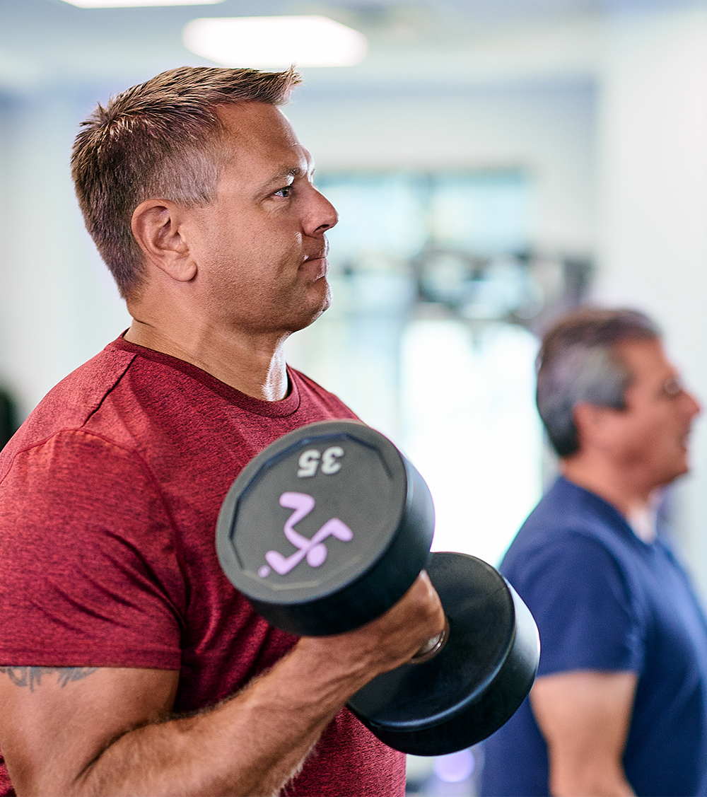 a man doing a bicep curl with a dumbbell