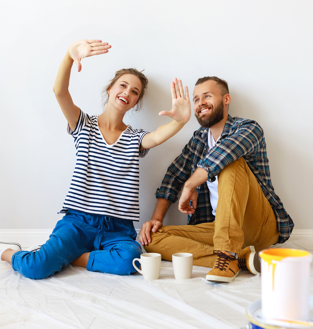 Husband and wife smiling on the floor