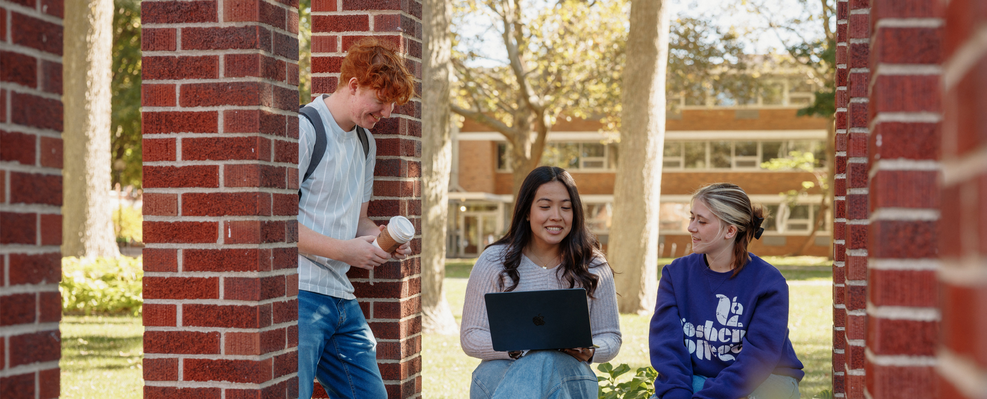students huddled in group on a college campus