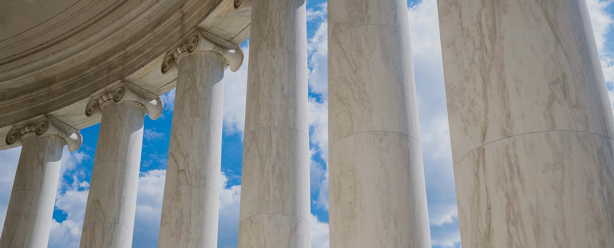 Scenic view of white marble neoclassical columns from the interior of the rotunda at the Jefferson Memorial in Washington DC, USA