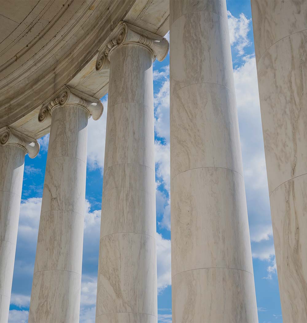 Scenic view of white marble neoclassical columns from the interior of the rotunda at the Jefferson Memorial in Washington DC, USA