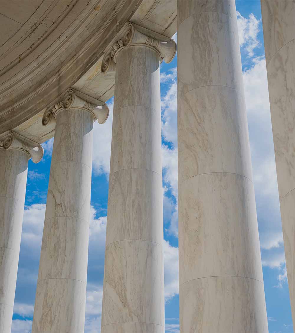Scenic view of white marble neoclassical columns from the interior of the rotunda at the Jefferson Memorial in Washington DC, USA