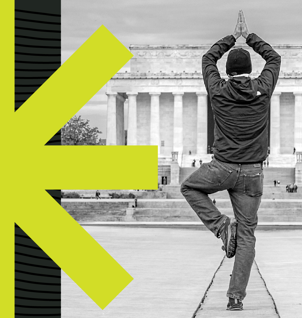 A man is doing yoga in front of the Lincoln Memorial.