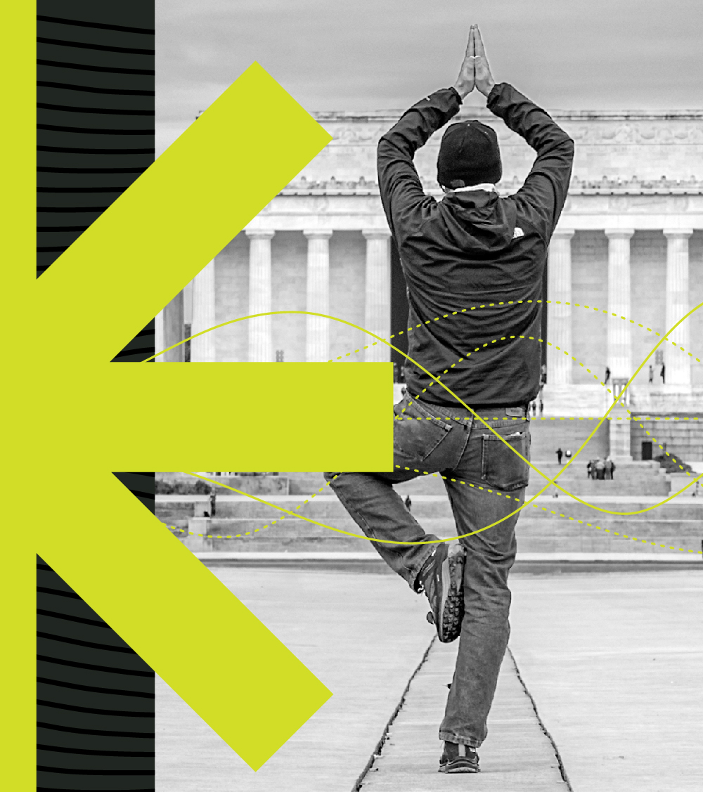 A man is doing yoga in front of the Lincoln Memorial.